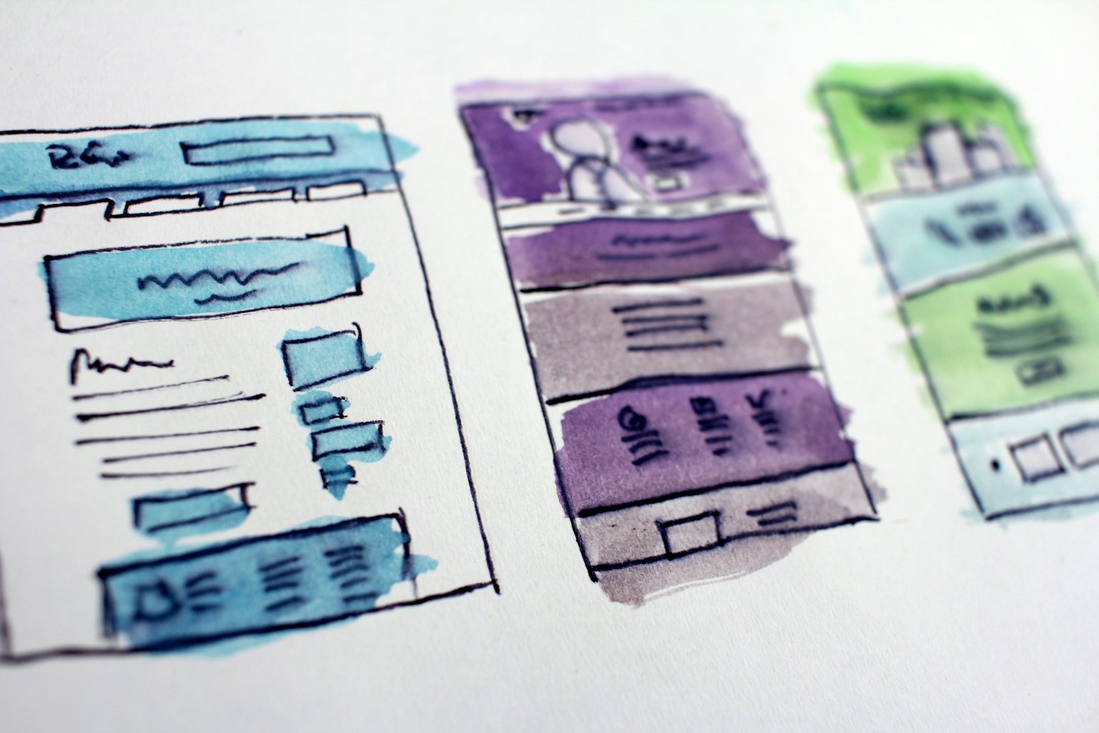 Website wireframe sketches and planning notes on a desk